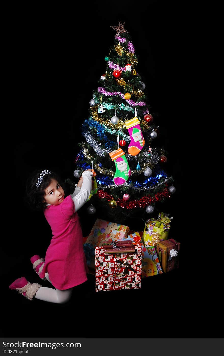 A girl and a christmas tree with presents. A girl and a christmas tree with presents