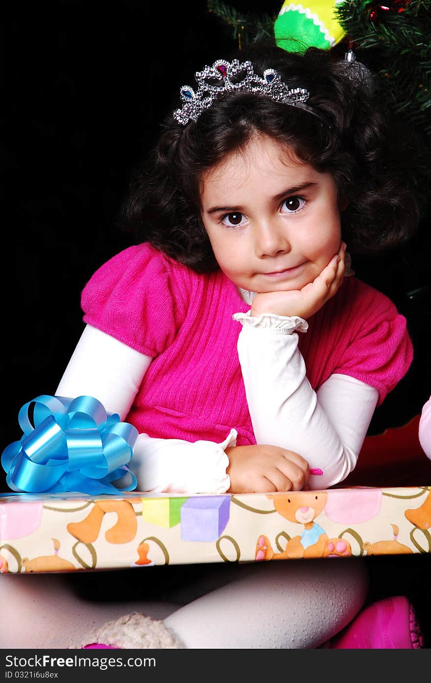 A girl and a christmas tree with presents. A girl and a christmas tree with presents