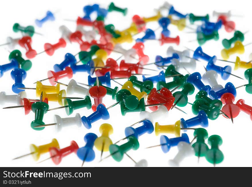 Colored Push Pins on white background.