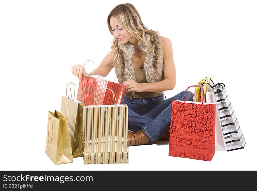 blond woman with shopping bags smiling happily. blond woman with shopping bags smiling happily