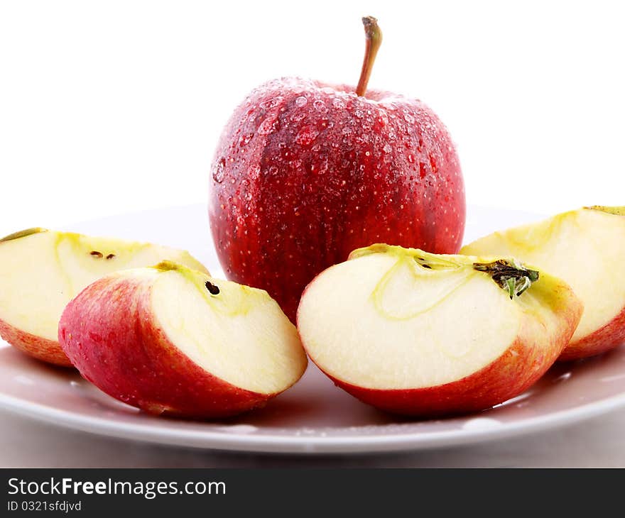 Red apples on white plate towards white background