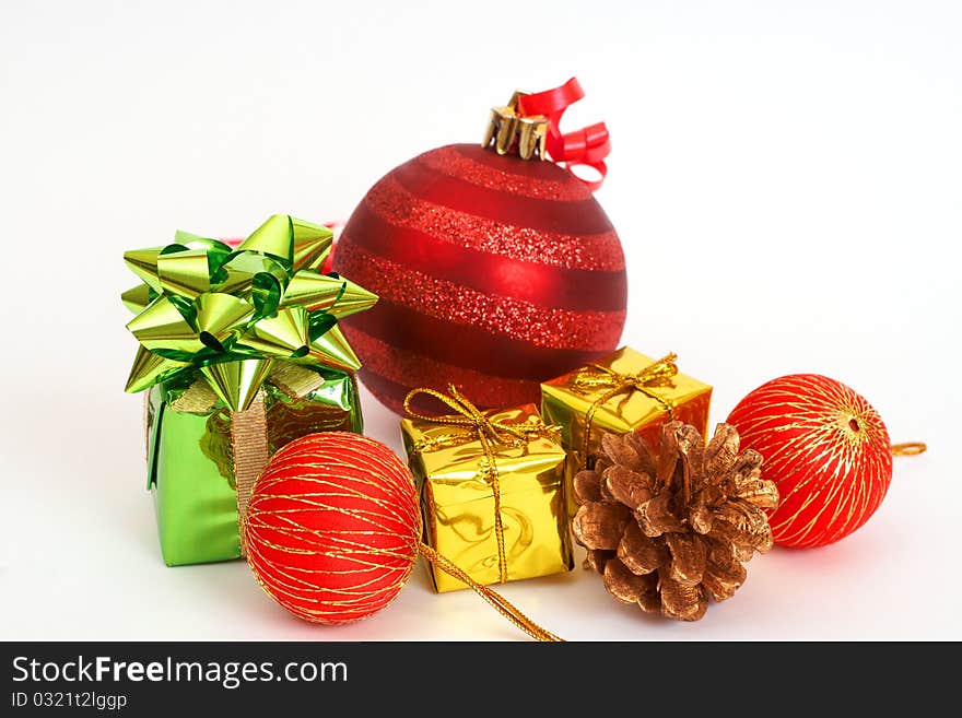 Red Christmas baubles and other decorations on light background with copy space.