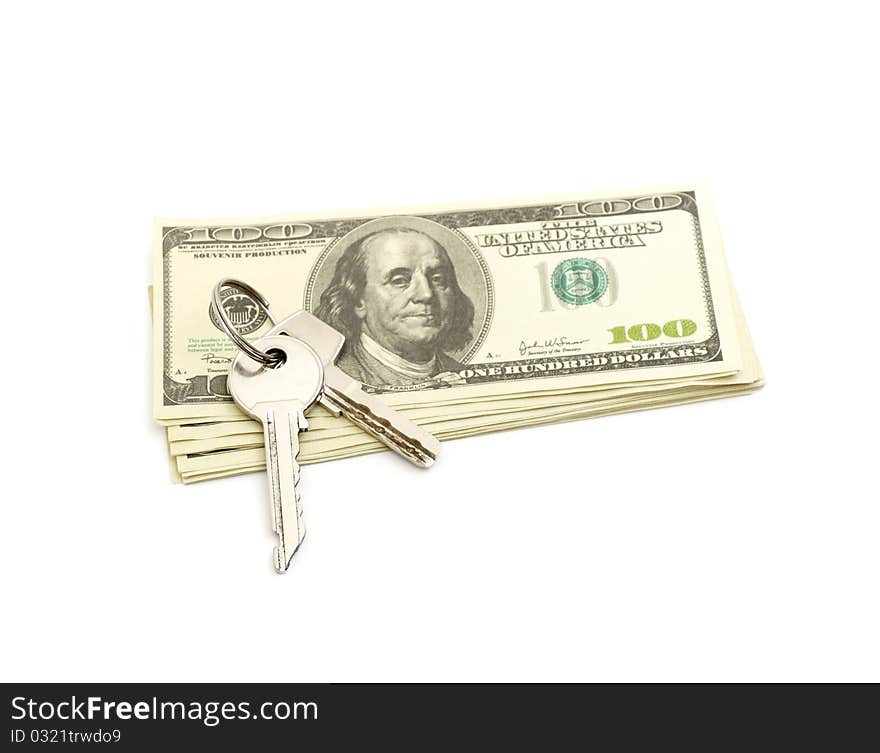 Keys and stack of dollars isolated on a white background