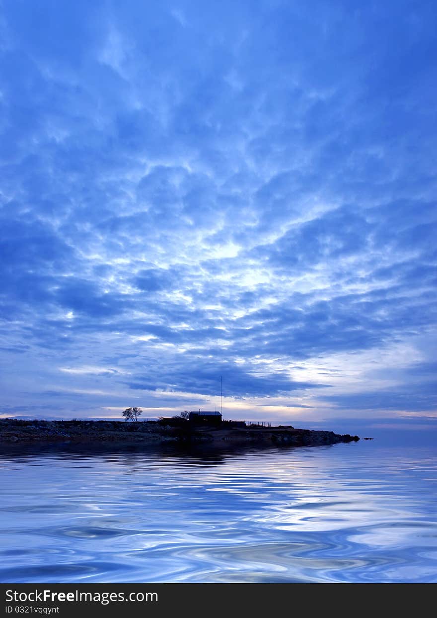 Sea and reflection in water during sundown