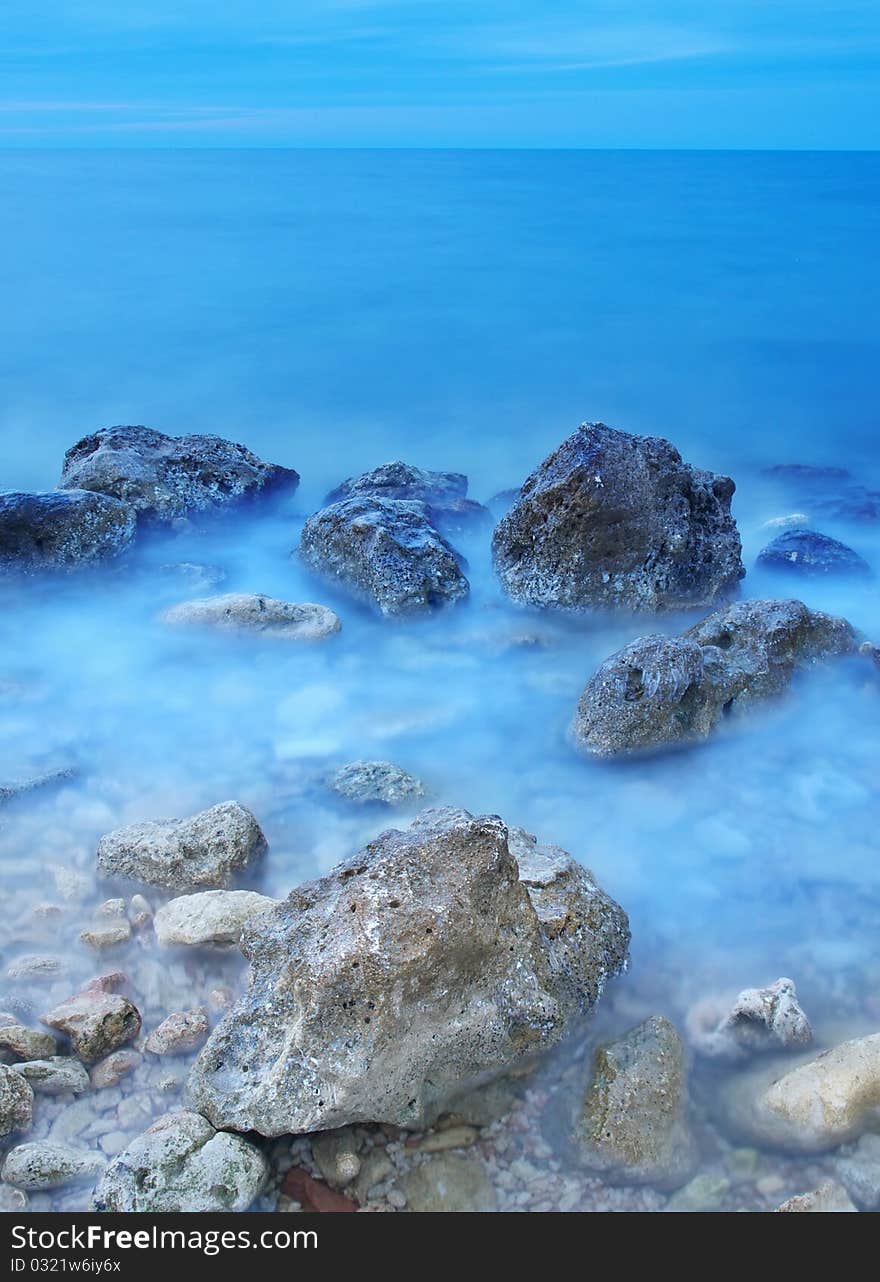 Sea and mist on water during sundown