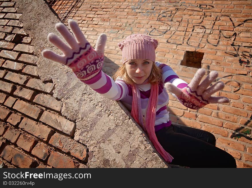 Beautiful young woman against the backdrop of a brick wall. Beautiful young woman against the backdrop of a brick wall