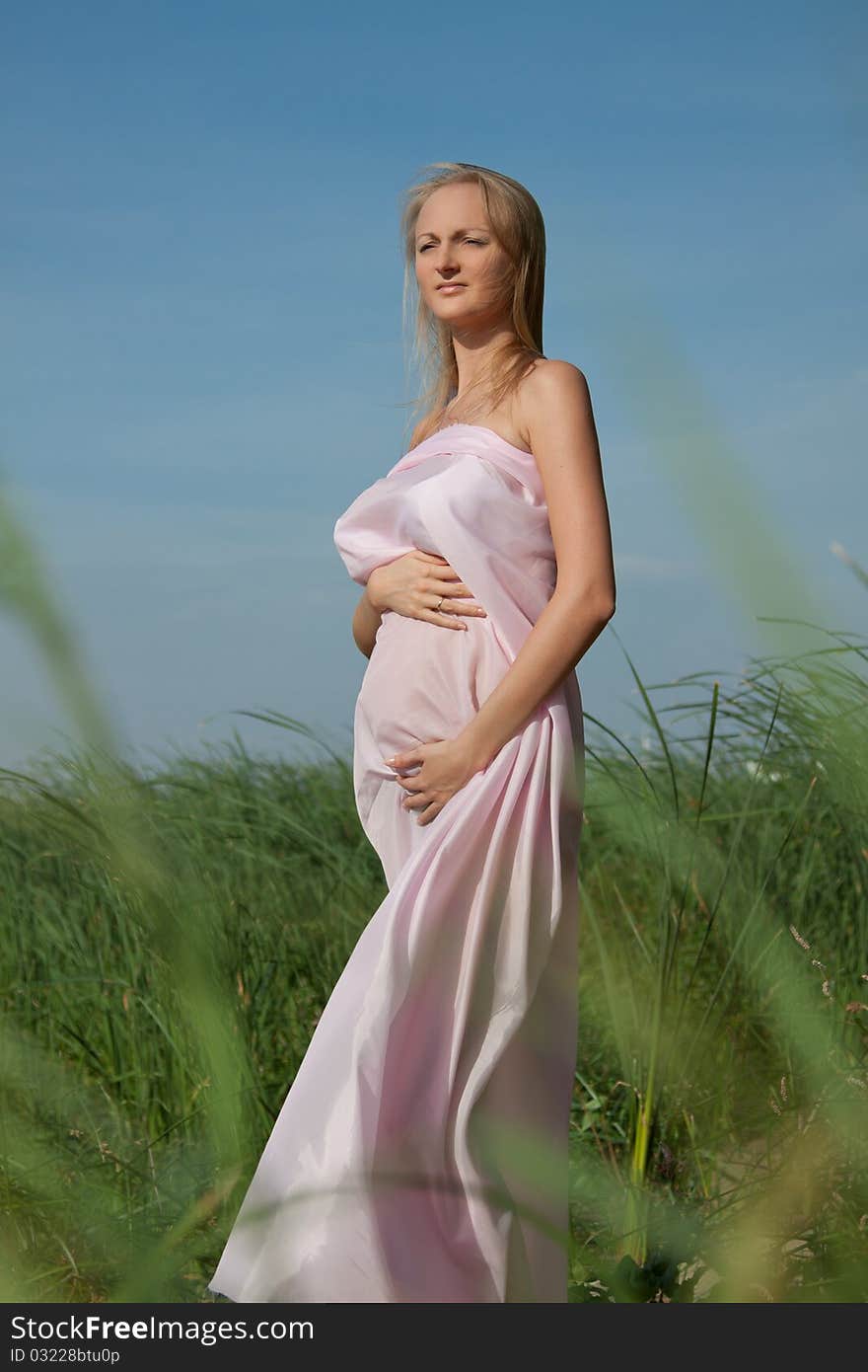 Beautiful pregnant woman in nature.