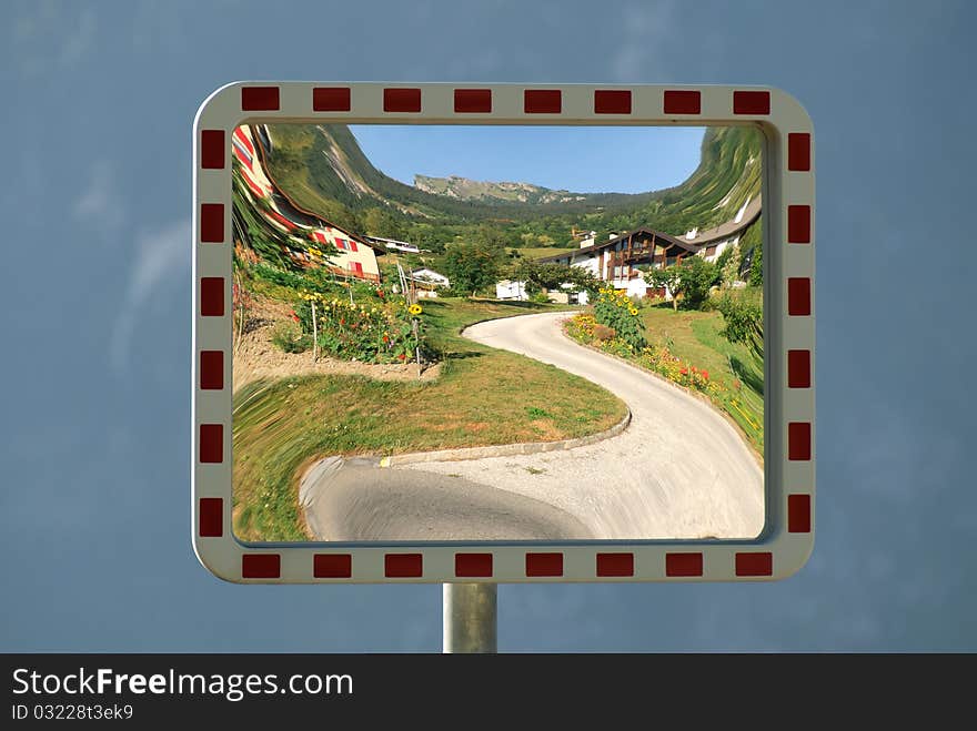 Photo of a tree in bloom on a mirror of road signs in Switzerland. Photo of a tree in bloom on a mirror of road signs in Switzerland