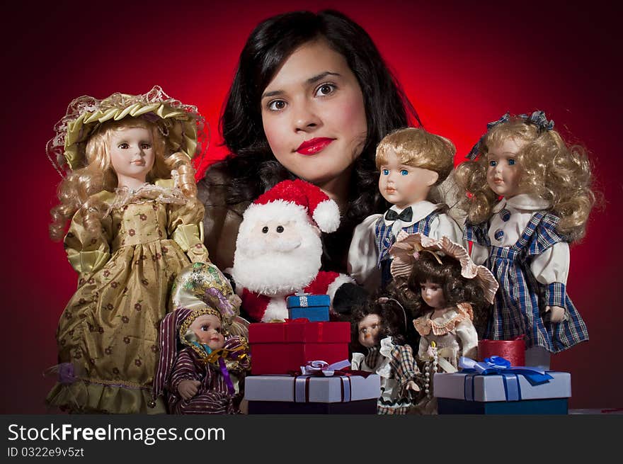 Young female with her dolls and santa claus receiving christmas gifts. Young female with her dolls and santa claus receiving christmas gifts