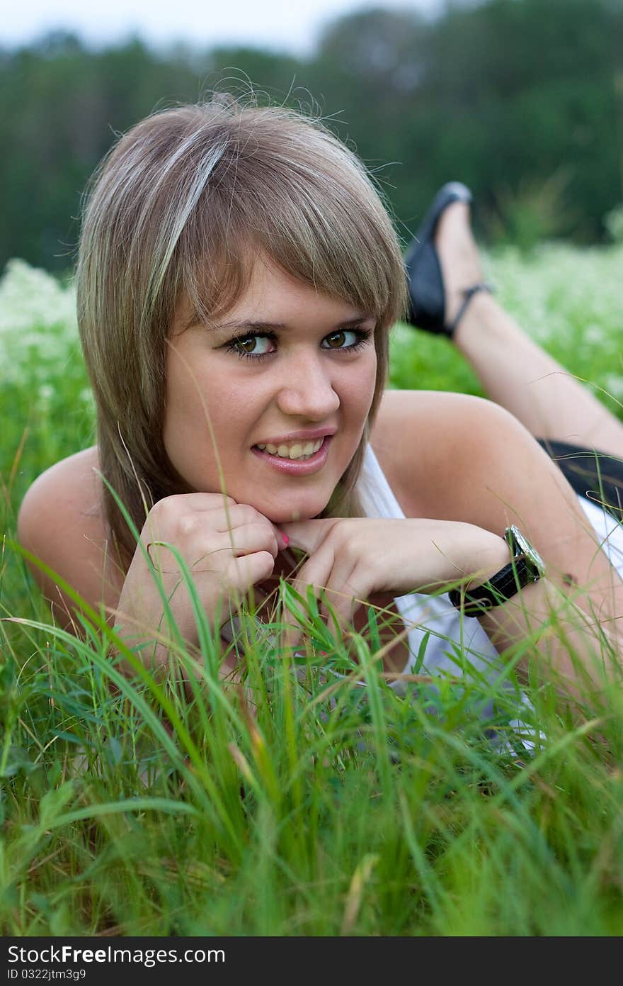 Beautiful girl lying on the grass. Beautiful girl lying on the grass