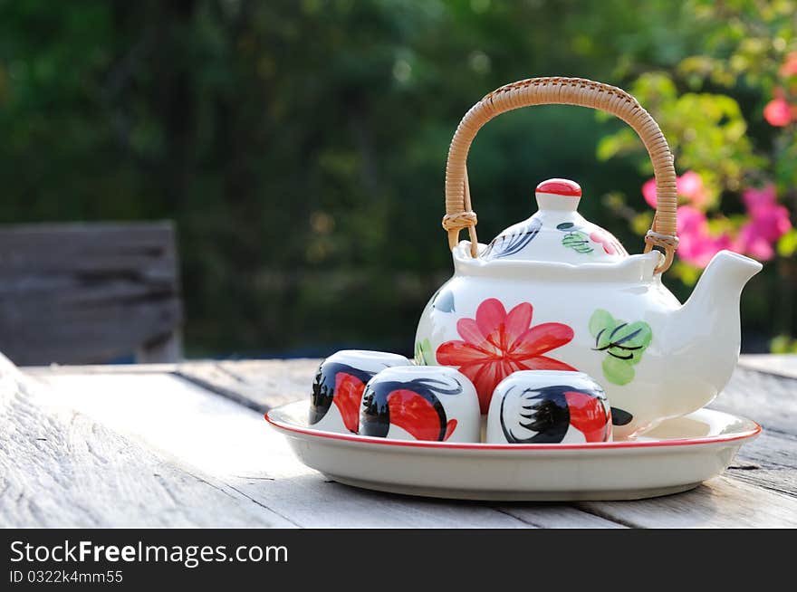 Teapot and cups on the table in the morning. Teapot and cups on the table in the morning.