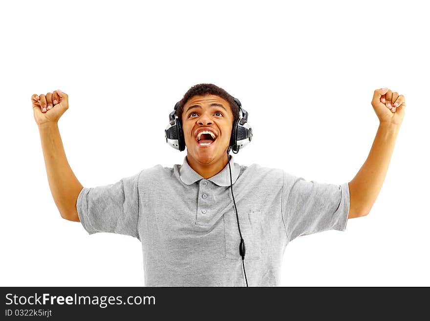 Young happy man listening to music and singing