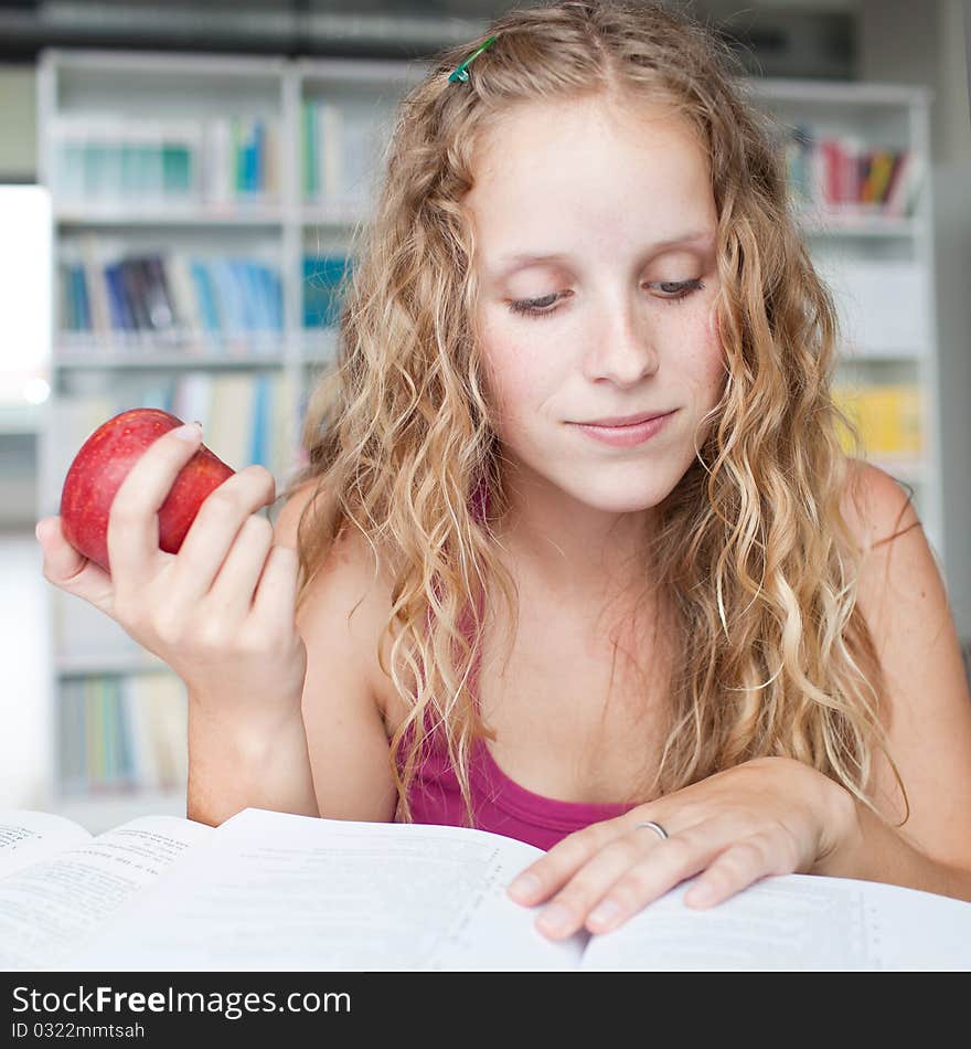 Pretty female college student in a library (shallow DOF; color toned image)