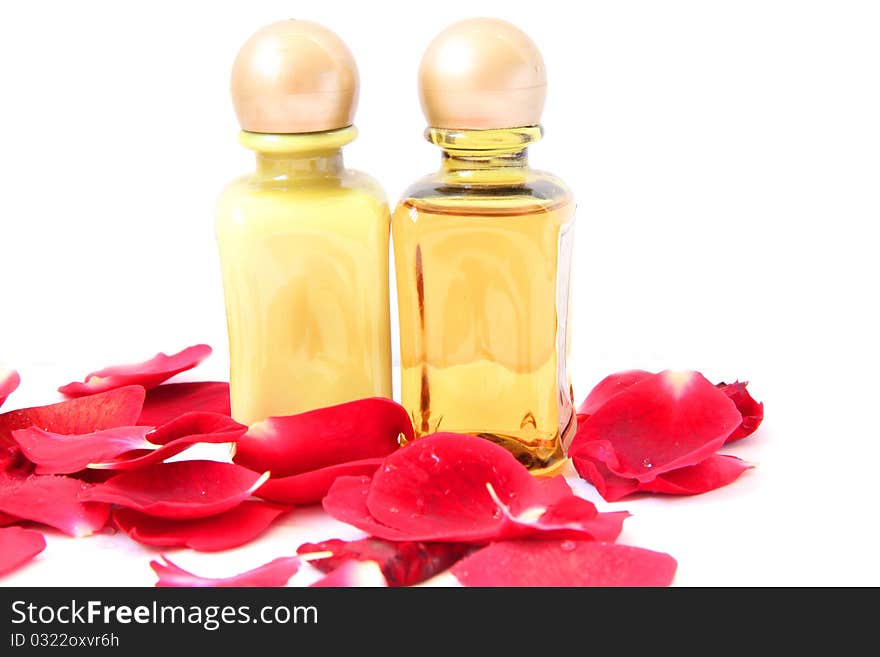 Spa treatment beautiful spa background. Natural Cosmetics cream and shampoo or massage oil with rose petals isolated on a white background