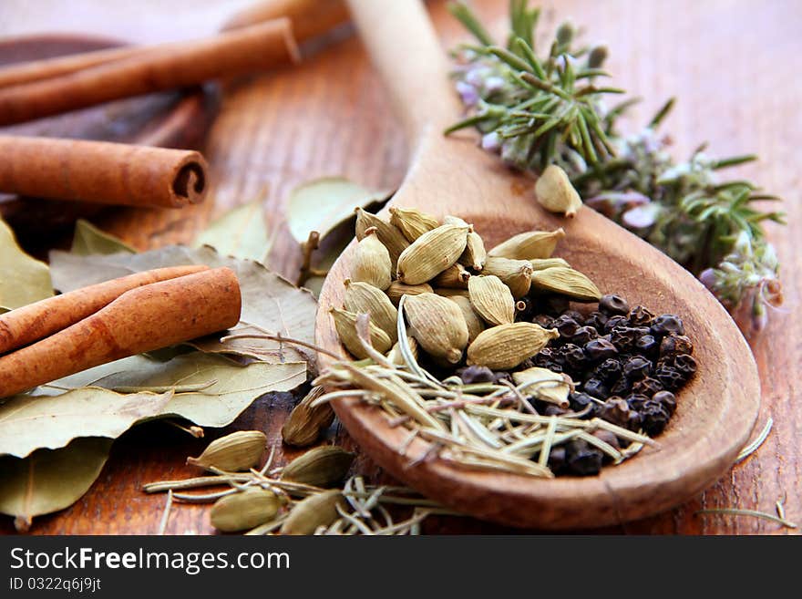 Macro view of the different spices on wooden background