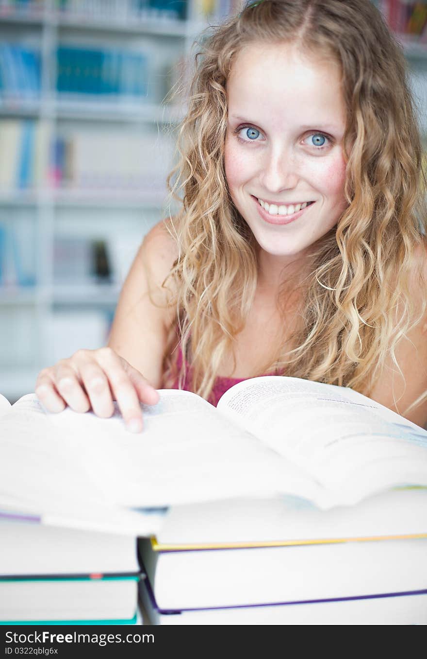 Pretty female college student in a library (shallow DOF; color toned image)