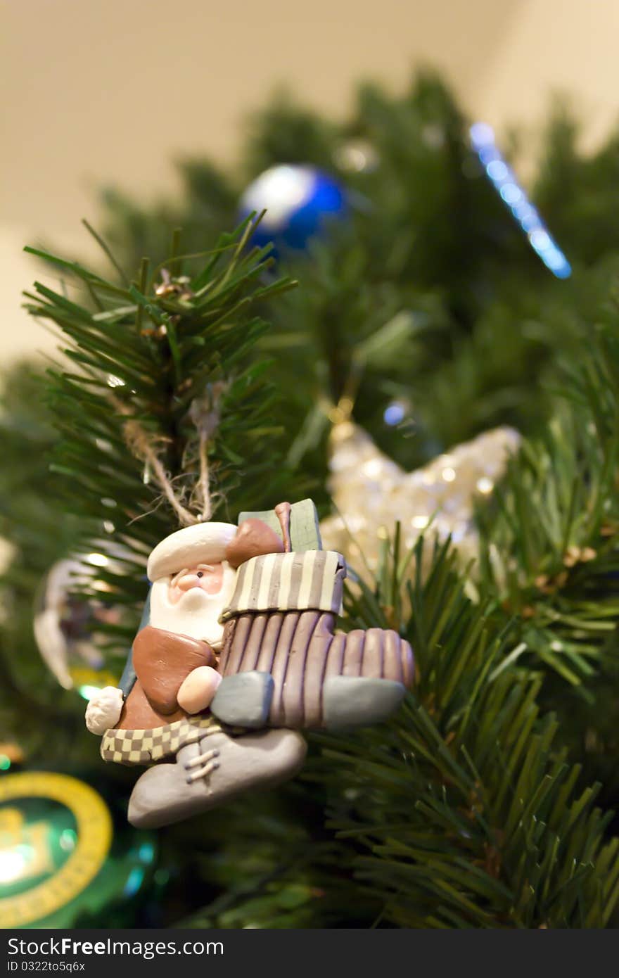 A Christmas Tree with a Santa ornament hanging from it. A Christmas Tree with a Santa ornament hanging from it.