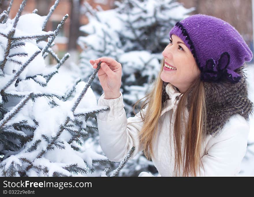 A young girl touched his hand a branch eating, winter, snow