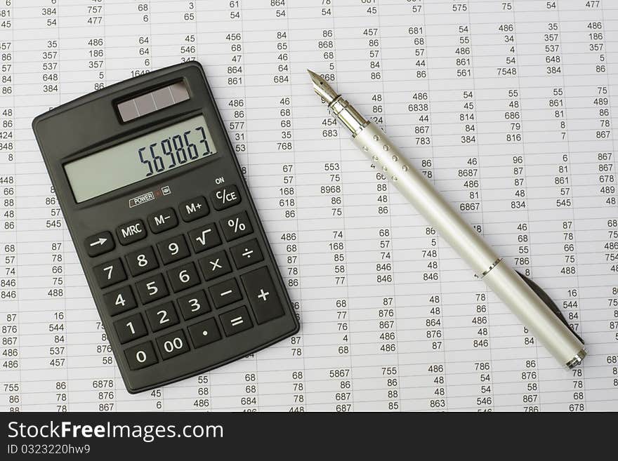 Calculator and pen on a white background. Calculator and pen on a white background