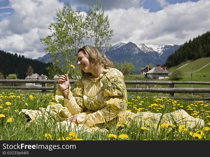 Medieval lady smelling a flower. The photo is taken in a village called Fundata near Brasov, Romania. Photo taken on: May 23rd, 2010