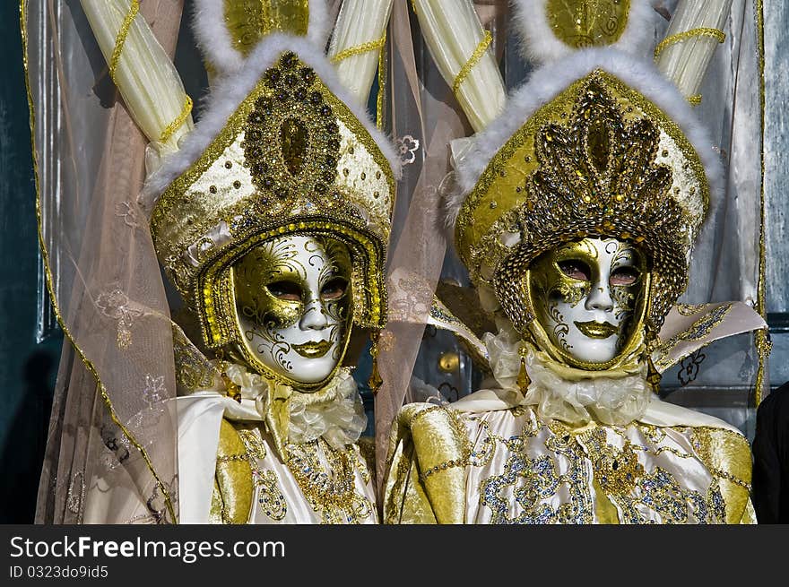 Carnival of Venice couple of goldne mask on the place of san marco. Carnival of Venice couple of goldne mask on the place of san marco