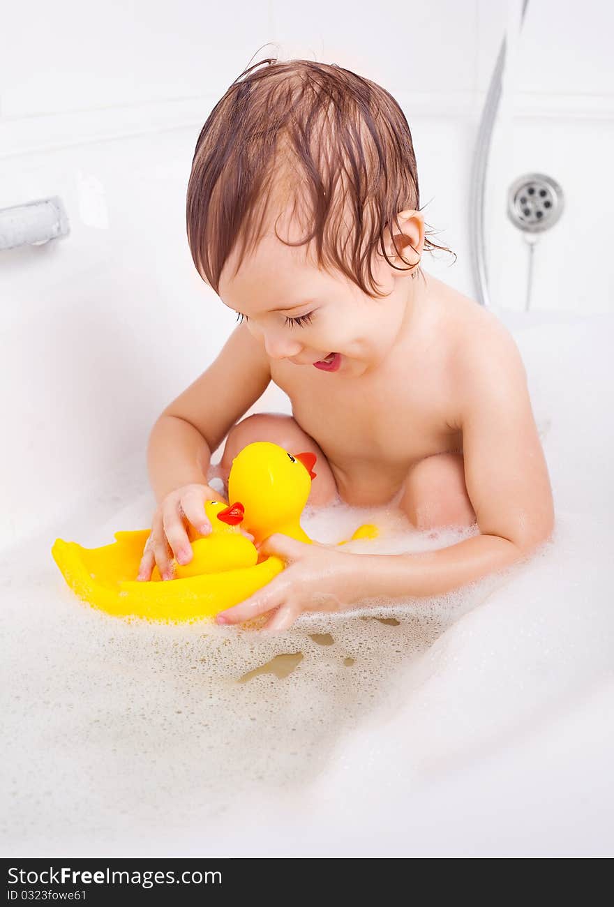 Beautiful little boy taking a relaxing bath with foam. Beautiful little boy taking a relaxing bath with foam