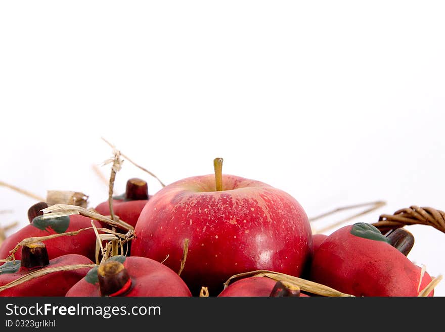 Red apples in a basket with straw and copyspace