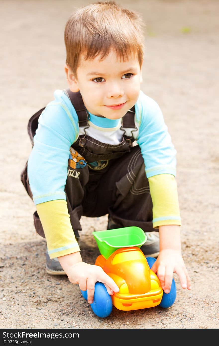 Little boy playing in the toy car