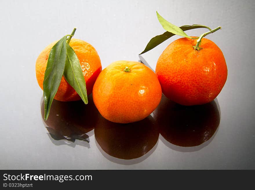 Mandarin oranges isolated on black gloss. Mandarin oranges isolated on black gloss