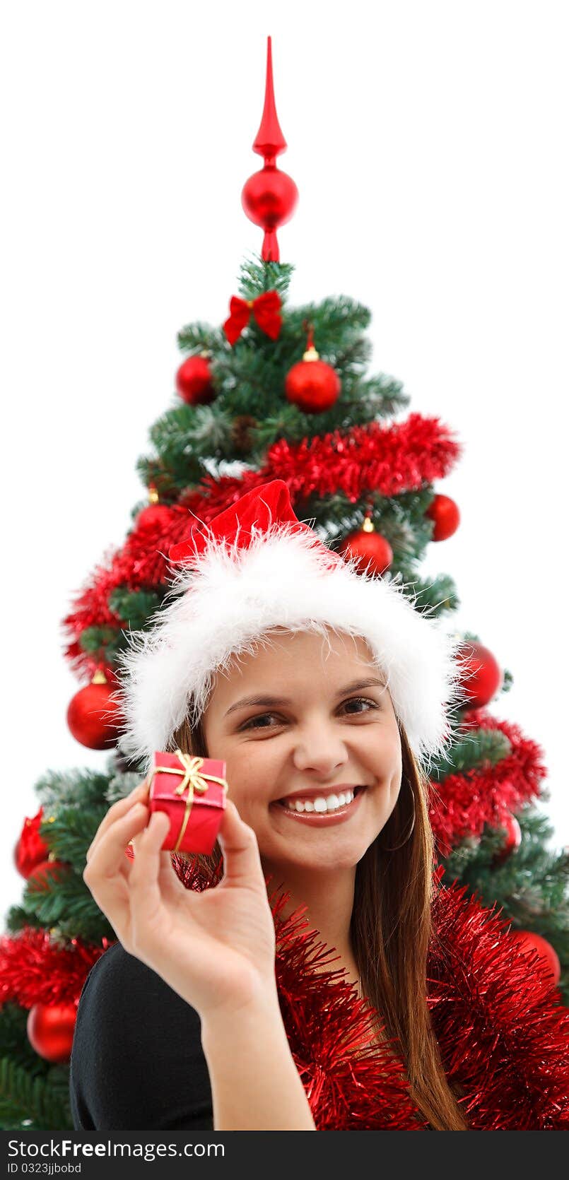 Young beautiful woman with a gift near the Christmas tree. Young beautiful woman with a gift near the Christmas tree