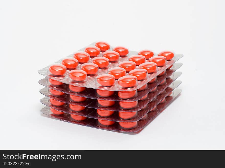 Orange tablets in transparent packing. Orange tablets in transparent packing