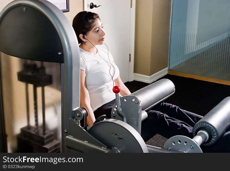 Young woman working out in an indoor gym. Young woman working out in an indoor gym.