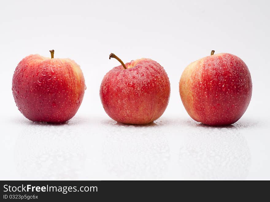 Row of red apples with waterdrops