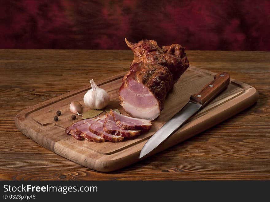 Composition with smoked ham on the table