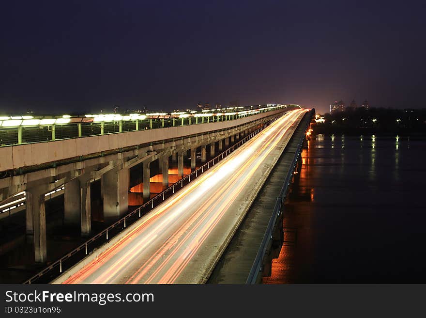 Movement of vehicles on the bridge at night. Movement of vehicles on the bridge at night