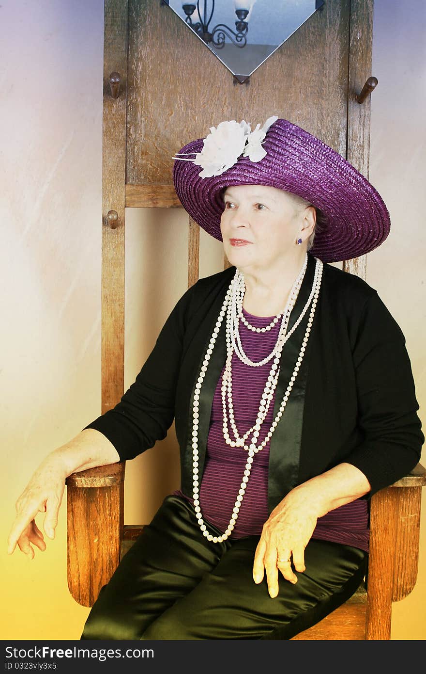 Adult female wearing a purple hat with white flower. Adult female wearing a purple hat with white flower