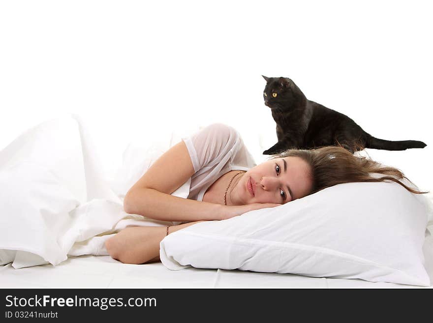 Woman in a bed with her black cat. Woman in a bed with her black cat