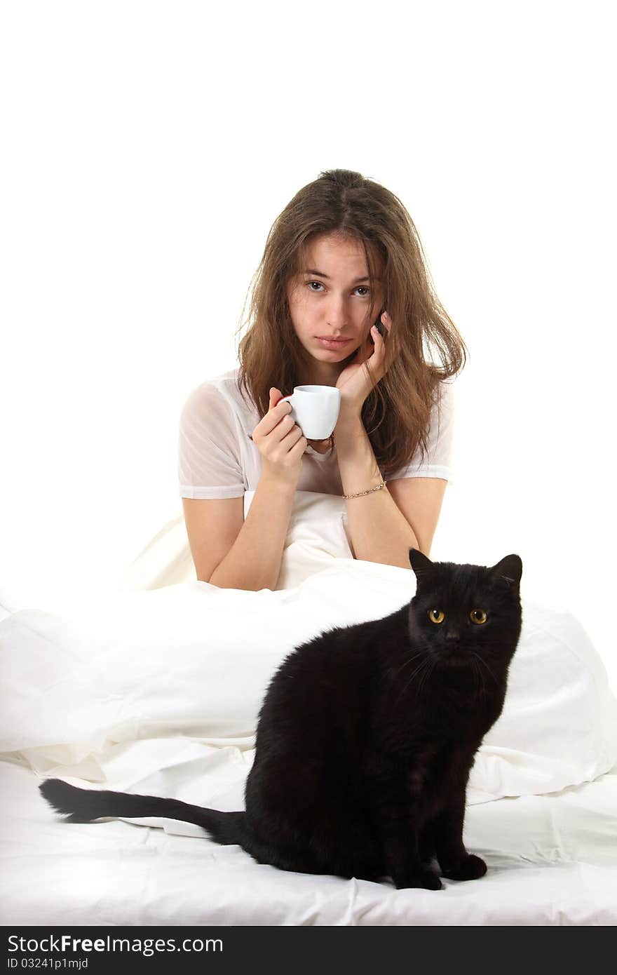 Woman in a bed with her black cat. Woman in a bed with her black cat