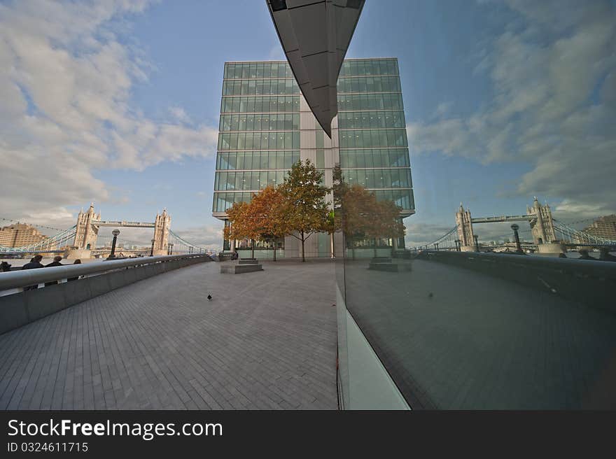 Modern building in london with clouds and the towerbridge in the background