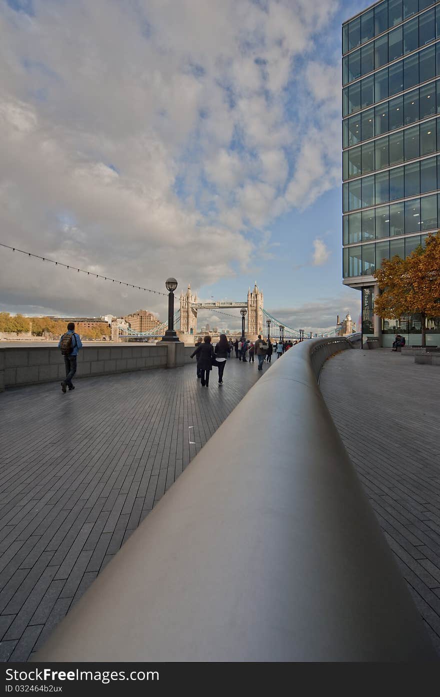 Modern building in london with clouds and the towerbridge in the background