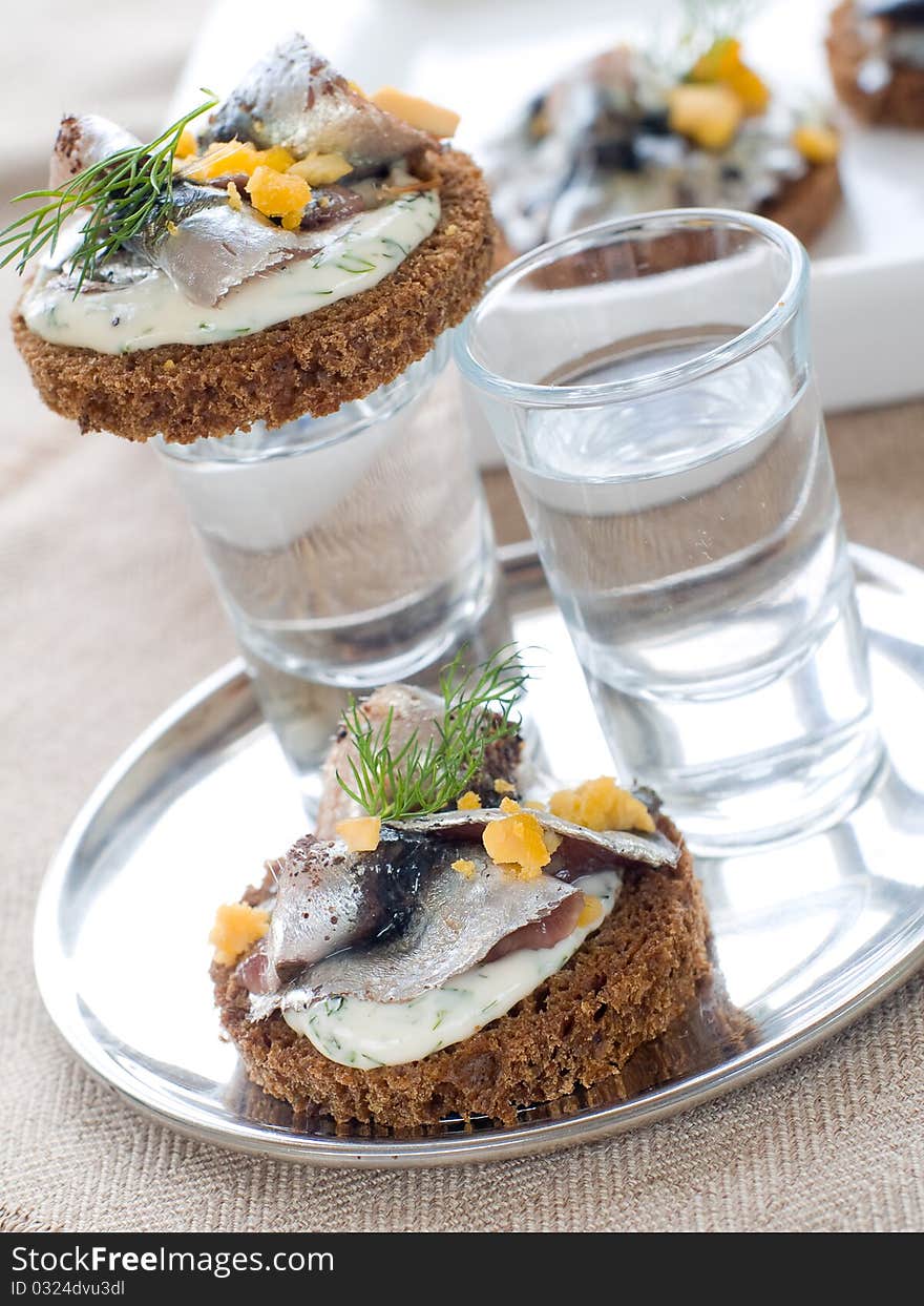 Anchovy canapes garnished with dill and yolk and vodka. Anchovy canapes garnished with dill and yolk and vodka