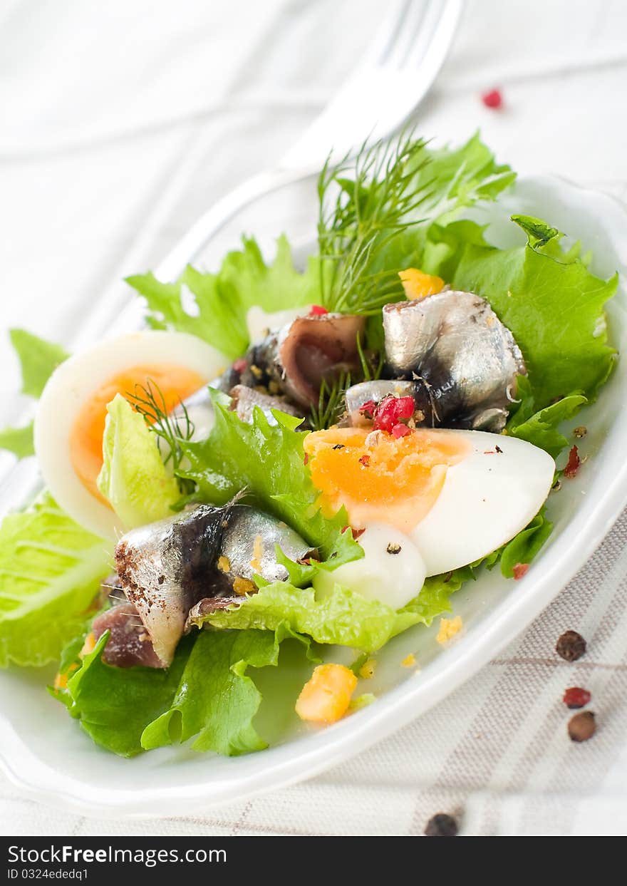 Salad with lettuce, eggs and anchovy on kitchen towel