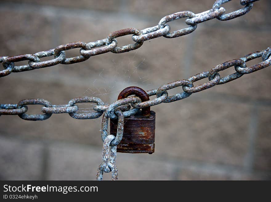 Chain and lock in front of cinderblock. Chain and lock in front of cinderblock.