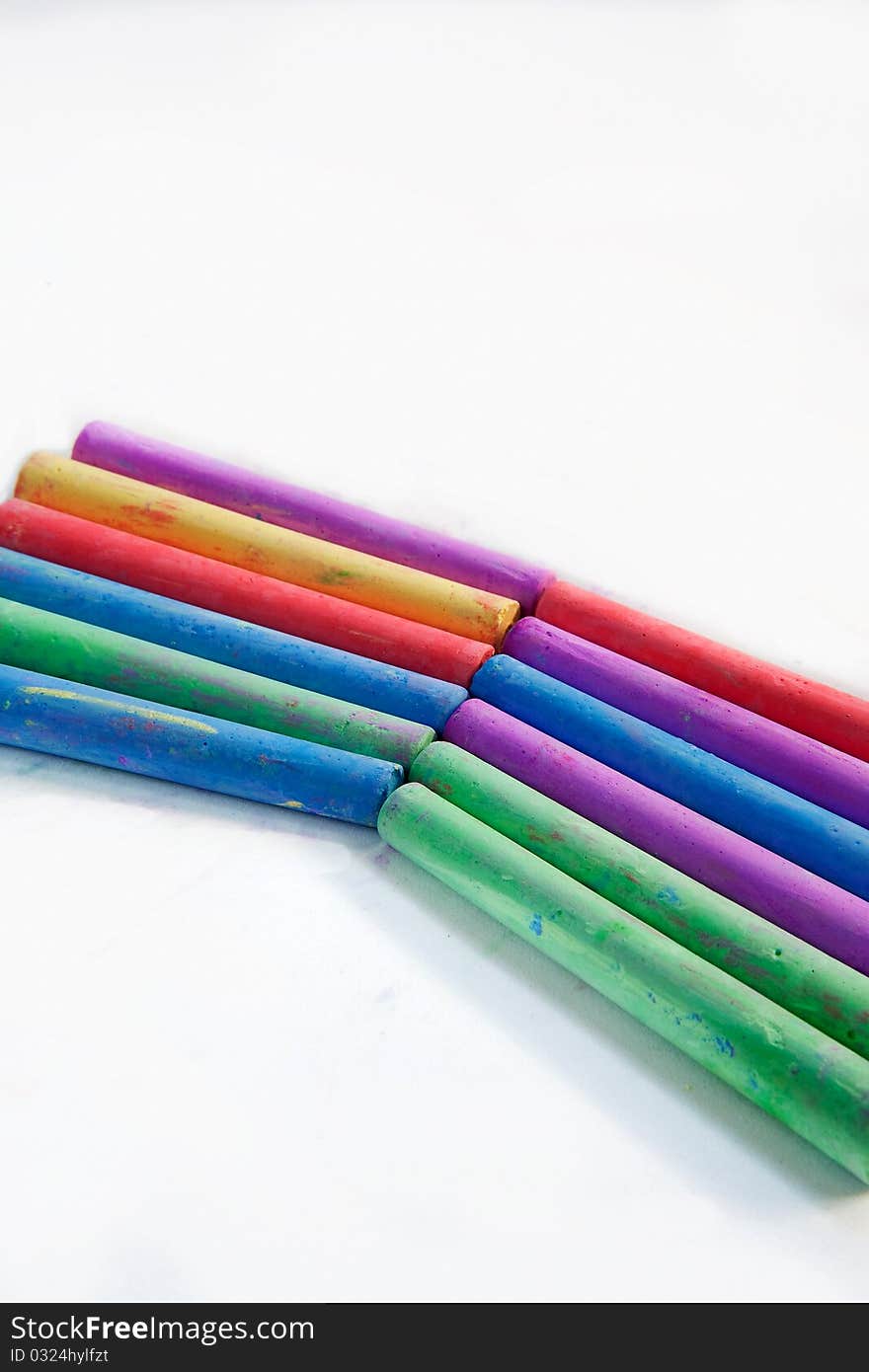 Colored chalks on a white background