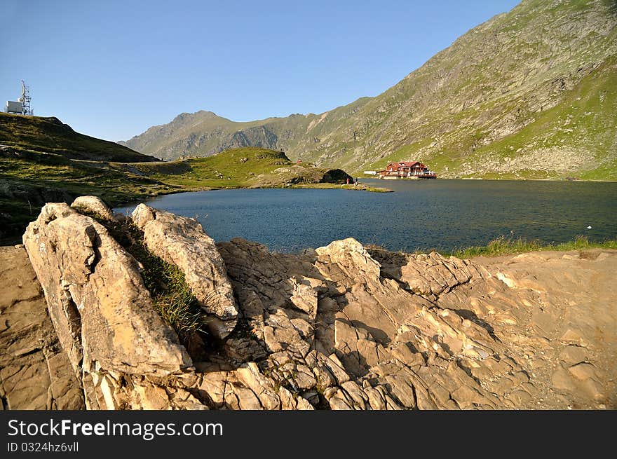 The Bâlea Lake is a glacier lake situated at 2,034 m of altitude in the Făgăraş Mountains, in central Romania, in Sibiu County. There are two chalets opened all the year round, a meteorological station and a mountain rescue station. It is accessible by car on the Transfăgărăşan road during the summer, and the rest of the year by a cable car from the Bâlea Waterfall chalet. The resort offers nature trails medium-advanced class, is a real paradise for lovers of extreme sports. Here you can practice ski, snowboard, gave the bag, sleighing, etc.. Partia Balea Lac is one of the most popular ski slopes in Romania by professionals and those who love extreme sports. Snow is present in November / December to July and has a very good quality for carrying ski’s. The photo was taken this summer, on a road trip and it was a very foggy day. This dreamy landscape is spectacular and the traditional cabin on the lake is wonderful. The Bâlea Lake is a glacier lake situated at 2,034 m of altitude in the Făgăraş Mountains, in central Romania, in Sibiu County. There are two chalets opened all the year round, a meteorological station and a mountain rescue station. It is accessible by car on the Transfăgărăşan road during the summer, and the rest of the year by a cable car from the Bâlea Waterfall chalet. The resort offers nature trails medium-advanced class, is a real paradise for lovers of extreme sports. Here you can practice ski, snowboard, gave the bag, sleighing, etc.. Partia Balea Lac is one of the most popular ski slopes in Romania by professionals and those who love extreme sports. Snow is present in November / December to July and has a very good quality for carrying ski’s. The photo was taken this summer, on a road trip and it was a very foggy day. This dreamy landscape is spectacular and the traditional cabin on the lake is wonderful.