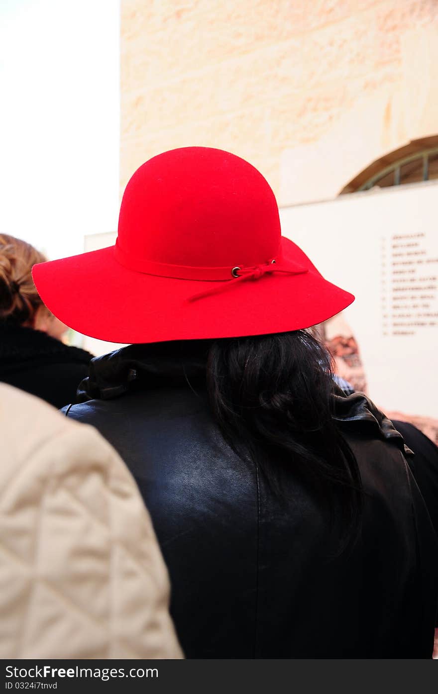 A woman wears red hat