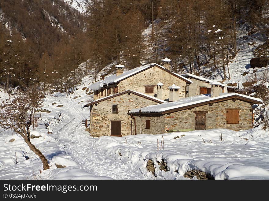 Cabins in a mountain valley in the North of Italy during winter. Valle delle Messi, Brixia province, Lombardy region, Italy. Cabins in a mountain valley in the North of Italy during winter. Valle delle Messi, Brixia province, Lombardy region, Italy