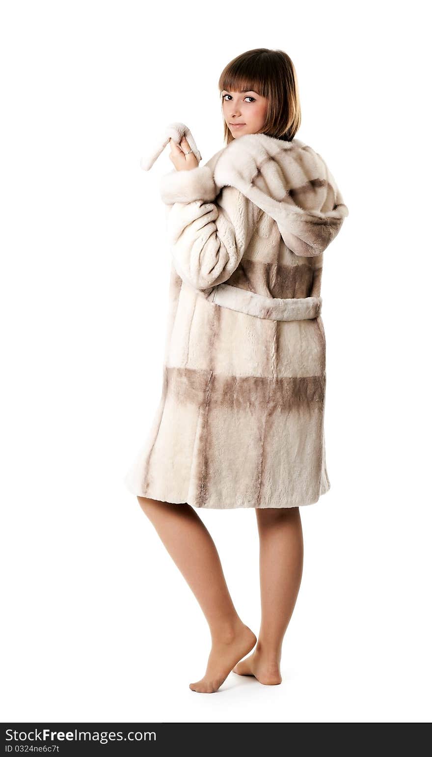 A beautiful young girl in a fur coat