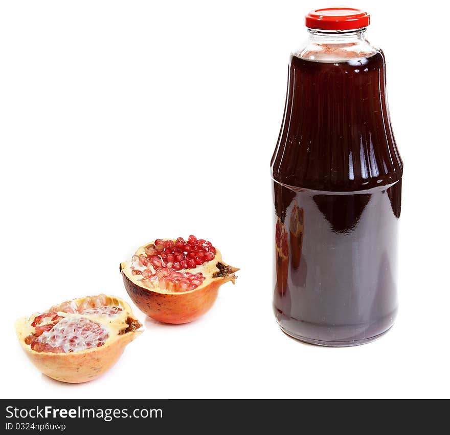 Bottle of juice and ripe piece grenade on white background