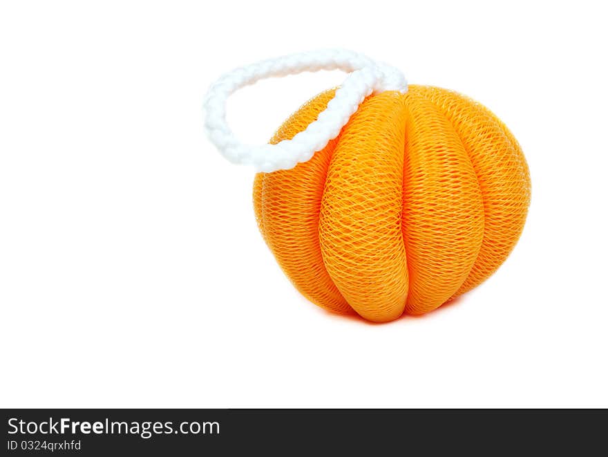 Yellow sponge in the shape of a pumpkin on a white background